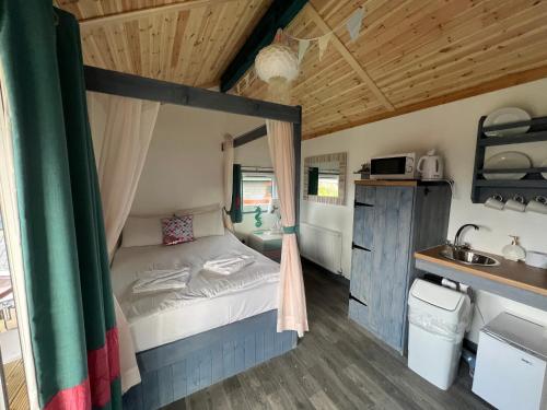 a small bedroom with a bed and a sink at Gulliver's Valley, M1, JCT 31 in Rotherham