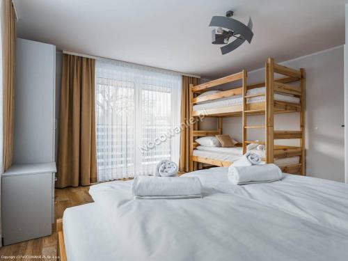 una camera con 2 letti e un letto a castello di Apartamenty Nad Rzeką a Kacwin