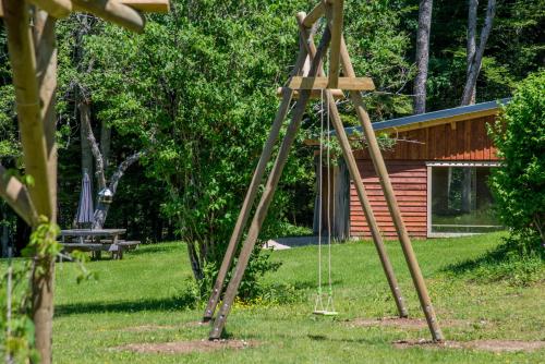 a swing set in the middle of a yard at Domaine de Malpas in Villers-le-Lac