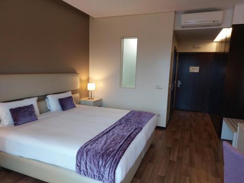 Кровать или кровати в номере Hotel Monte Lírio