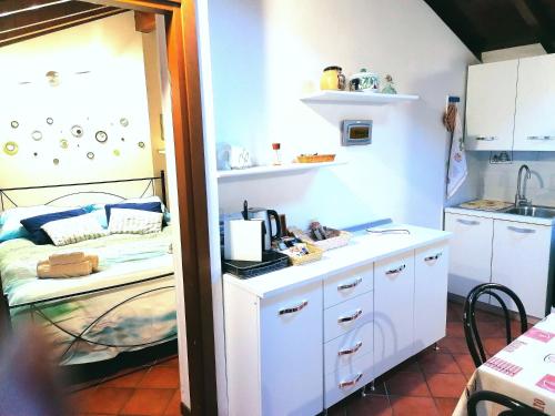 a small kitchen with a bed and a sink at La Casetta in Stresa