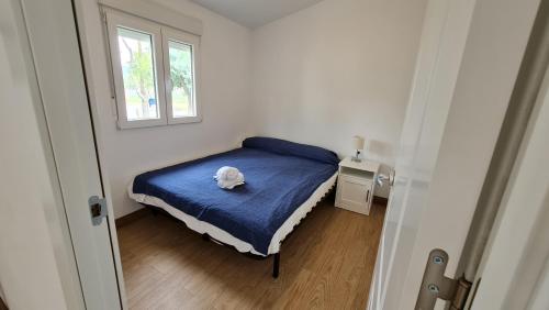 a bedroom with a bed with a stuffed animal on it at Sabiñanigo Camp & Hotel in Sabiñánigo