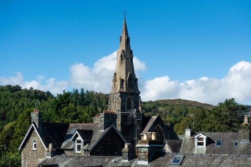 an old church with a steeple on top of roofs at The Lakes B and B in Ambleside