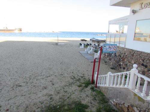 a building on the beach next to the ocean at GARRUCHA HOME AND BEACH in Garrucha