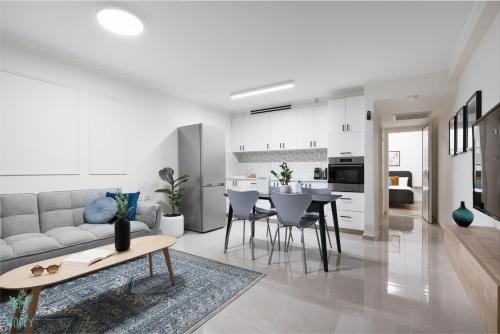a living room with a couch and a table at Mate ALMA - By HOMY in Jerusalem