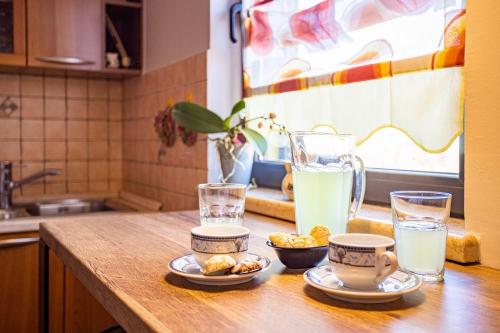 a kitchen counter with two glasses of milk and bowls of food at Villa Leona in Čabrunići