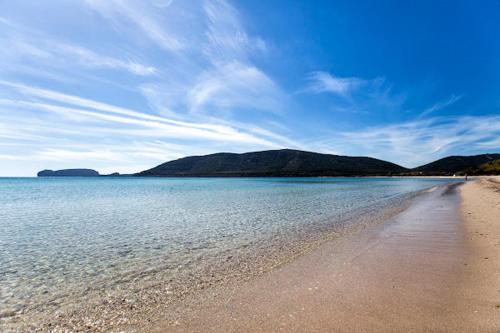 a view of a beach with mountains in the background at Alghero Old Town Gem - Emerald in Alghero