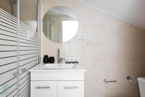a bathroom with a sink and a mirror at Mate ALMA - By HOMY in Jerusalem