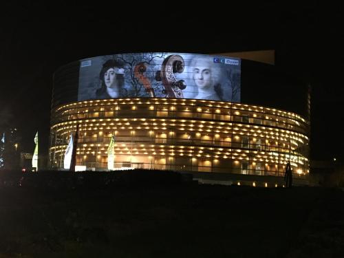a building with a billboard on top of it at night at La Maison D'Hôtes Nantes Centre in Nantes
