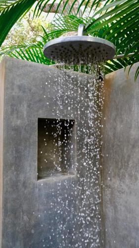 a fountain with a light on top of a wall at Mind Body and Soul in Dambulla