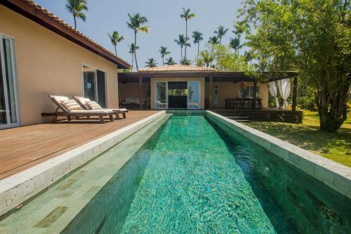 a swimming pool in the backyard of a house at Orixás Residence in Morro de São Paulo