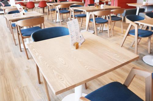 a row of tables and chairs in a cafeteria at Holiday Inn Express, Chester Racecourse by IHG in Chester