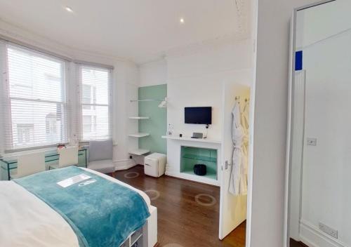 a white room with a bed and a television at Hotel Nineteen in Brighton & Hove