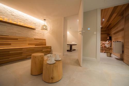 a woman sitting on a bench in a room at Chalet hôtel le Whymper in Chamonix-Mont-Blanc