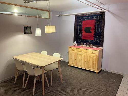 a dining room with a wooden table and chairs at Ferienwohnung CASA URSIN Val Lumnezia in Lumbrein