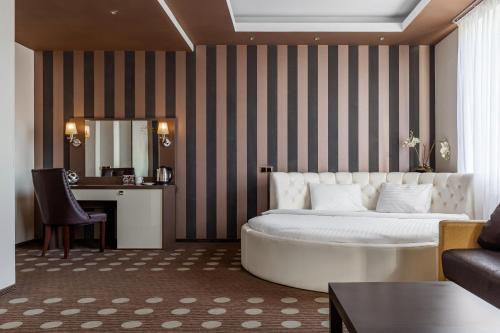 a hotel room with a bed and a desk at Ambassador Plaza in Kyiv