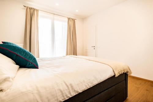 a bedroom with a bed with a large window at Tom's Seeblick Domizil in Unternarrach