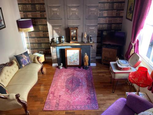a living room with a couch and a fireplace at Bedford House Retreat in Scarborough