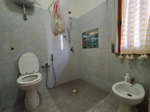 łazienka z toaletą i umywalką w obiekcie La Casa Bianca - Alghero Calich w mieście Alghero
