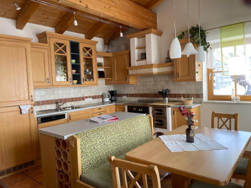 a kitchen with wooden cabinets and a wooden table at Villa Michelle in Obergurgl