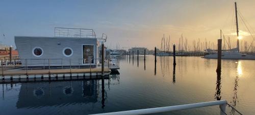a small house on a dock in the water at House Boat Rimini Resort in Rimini