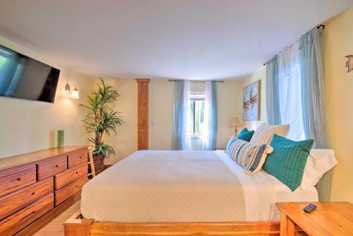a bedroom with a bed with a dresser and a tv at Riverfront Apt with Kayak Launch in Dunnellon in Dunnellon