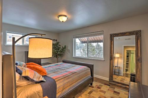 a bedroom with a bed and a mirror at Cozy Denver Home with Hot Tub, 2 miles to Dtwn! in Wheat Ridge