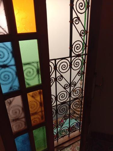 a door with a colorful glass and a gate at Riad Fes Touria Palace in Fès