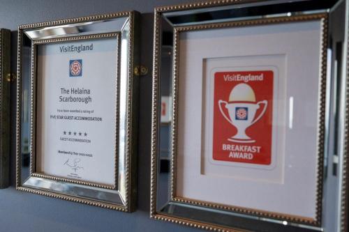 a pair of framed diploma frames on a wall at The Helaina in Scarborough