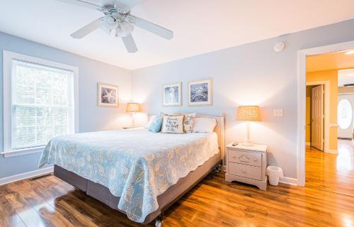 a bedroom with a bed and a ceiling fan at Gone With the Wind in Duck