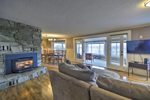a living room with couches and a stone fireplace at Breathtaking Port Ludlow Home with Deck and Yard in Port Ludlow