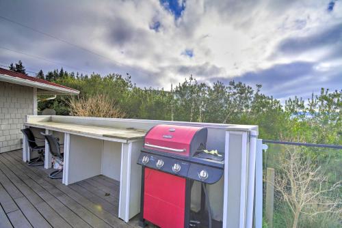a table on a deck with a pink appliance on it at Breathtaking Port Ludlow Home with Deck and Yard in Port Ludlow