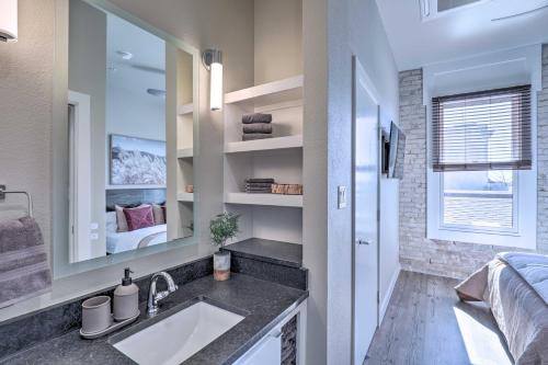 a bathroom with a sink and a mirror at Sleek, Newly Updated Downtown San Marcos Apt! in San Marcos