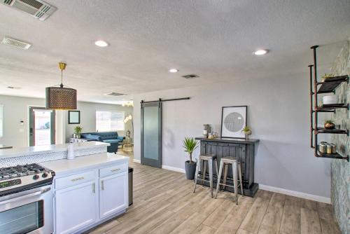 a kitchen and living room with a stove and a counter at Charming Phoenix Home with Patio about 3 Miles to Dtwn! in Phoenix