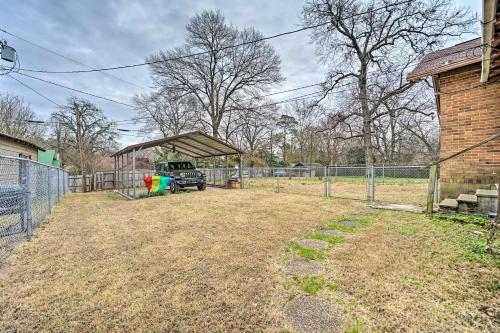 a truck parked in a yard next to a building at Texarkana Pet-Friendly Pad with Fenced Backyard in Texarkana