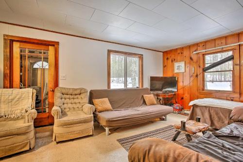 a living room with a couch and chairs and a tv at Remote Michigan Retreat on 10 Acres with Grill! in Irons