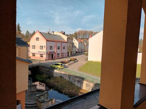 a view from a window of a town with a canal at Hotel Střelnice in Teplice nad Metují