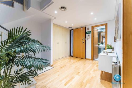 a hallway with white walls and a wooden floor at Super Deluxe Villa with FREE Parking Madrid Center in Madrid