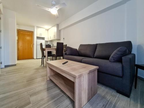 a living room with a couch and a table at Apartamento Narcea in Benidorm