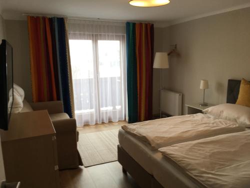 een slaapkamer met een bed en een groot raam bij Appartement Imbachhorn in Zell am See