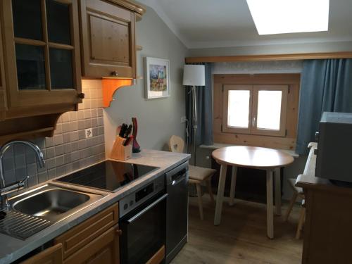 a kitchen with a sink and a stove top oven at Appartement Imbachhorn in Zell am See