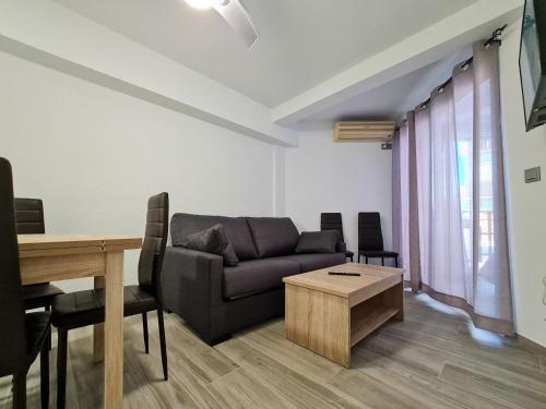 a living room with a couch and a table at Apartamento Narcea in Benidorm