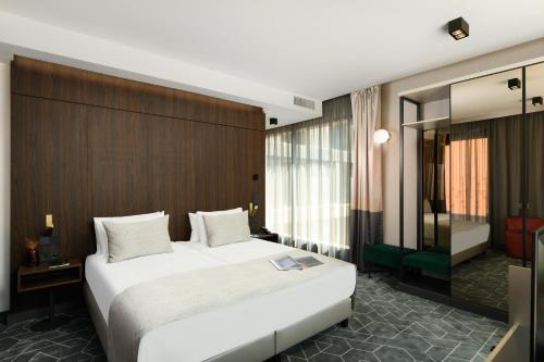 a bedroom with a large white bed in a room at Emerald Hotel by Continental Group in Budapest