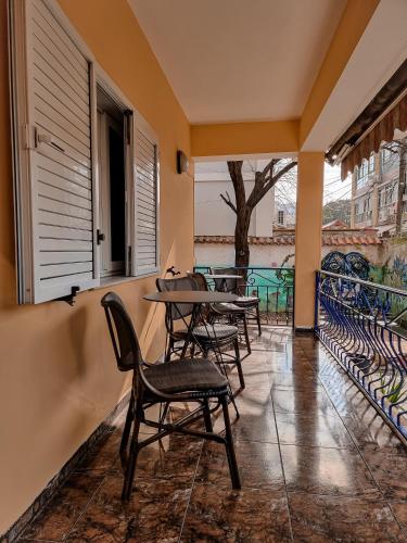 a patio with tables and chairs on a balcony at The Bearded Dad Hostel in Tirana