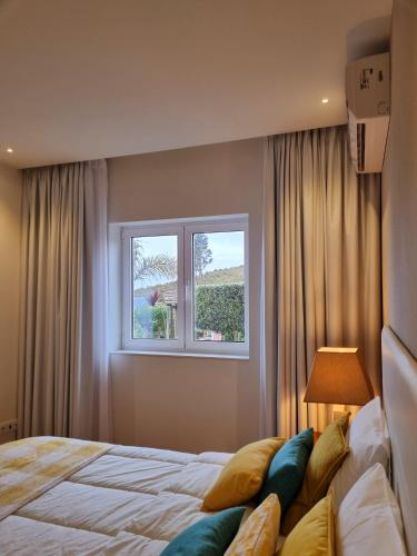 a bedroom with a bed and a window at Recanto Nature in Vila Verde