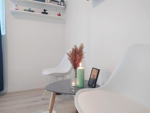 a table with a candle and a white chair at Seline Summer Home in Seline