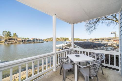 a porch with a table and chairs and a view of the water at The Hamilton - Lakefront & Studio Suites, Hot Springs in Hot Springs