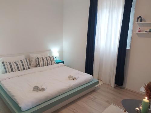 a bedroom with a bed with shoes on it at Seline Summer Home in Seline