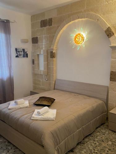 a bedroom with a bed with two towels on it at House Villa Anna in Polignano a Mare