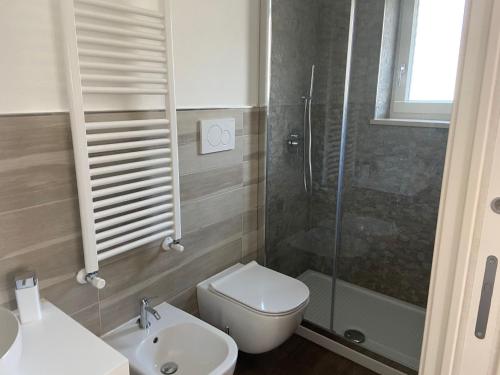 a bathroom with a toilet and a sink and a shower at House Villa Anna in Polignano a Mare